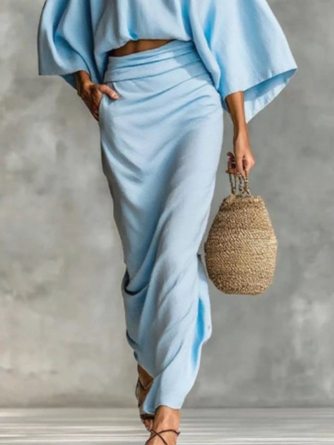 Kimono Sleeve Top and Ruched Skirt Set featuring an elegant blue two-piece outfit with stylish draping and a casual bag.