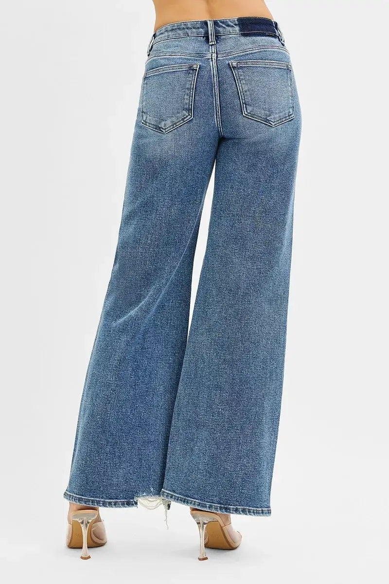 Back view of RISEN Tummy Control Mid Rise Fit Wide Jeans showcasing wide-leg design and distressed hem.