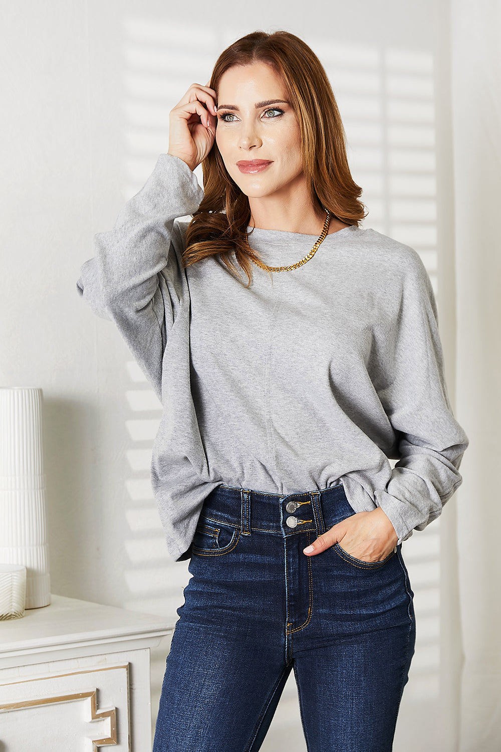 Double Take Seam Detail Round Neck Long Sleeve Top for Women styled with high-waisted jeans.