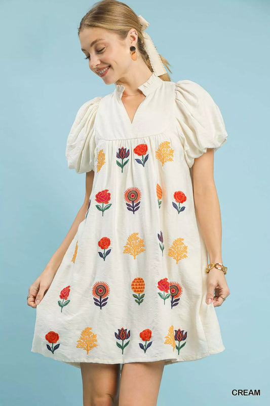 Umgee Floral Embroidered Mini Dress with Puff Sleeves in cream, featuring colorful floral embroidery and a flattering silhouette.