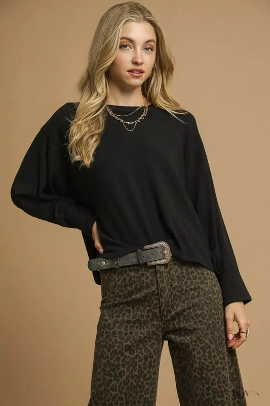 Model wearing a black Umgee Brushed Fleece Crewneck Top with leopard print pants and layered necklaces.