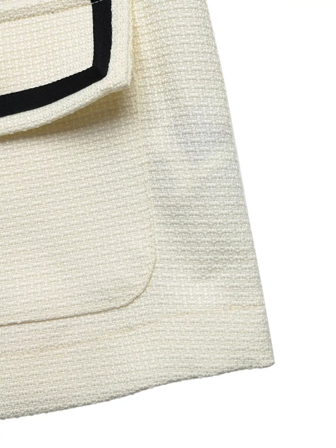Close-up of the fabric and pocket detail on the Contrast Trim Button-Up Blazer, showcasing its stylish texture.
