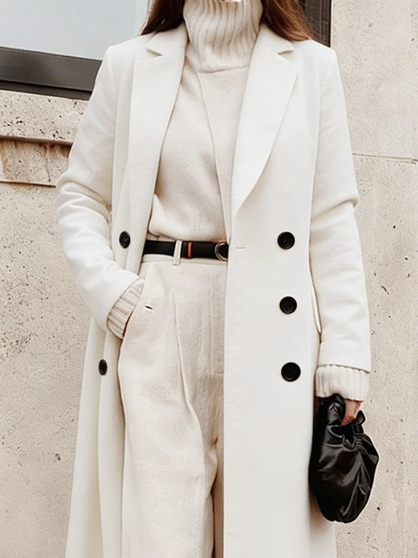 A model wearing a Double Breasted Longline Overcoat, showcasing its elegant design, paired with a stylish outfit.