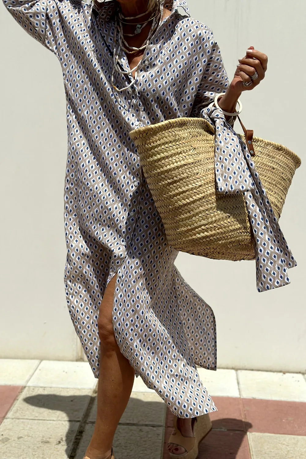 Tied Button Up Three-Quarter Sleeve Dress for Women, featuring a unique pattern, paired with a stylish straw bag.