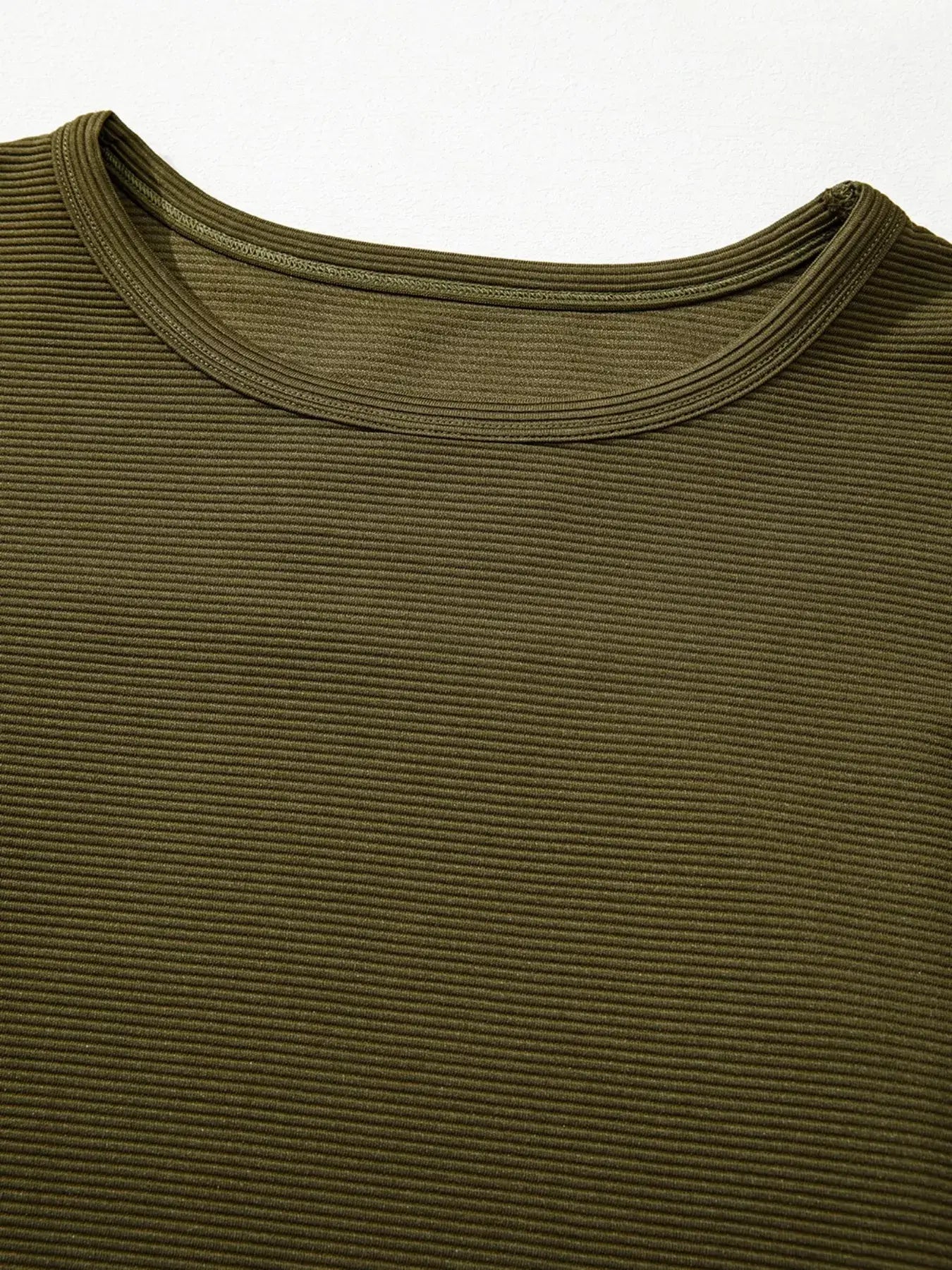 Close-up of the Ribbed Knit Oversized Sweatshirt showcasing its ribbed texture and neckline in an olive green color.
