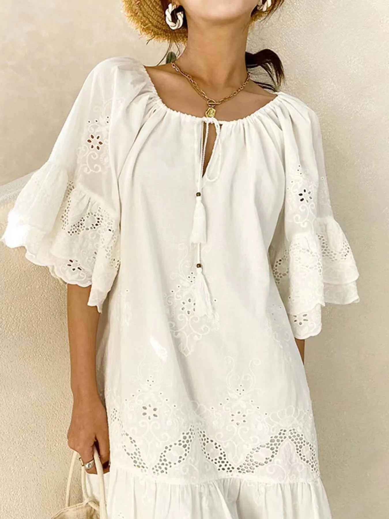Eyelet Embroidered Tassel Tie Neck Dress in white, featuring ruffled sleeves, eyelet detailing, and cotton fabric.