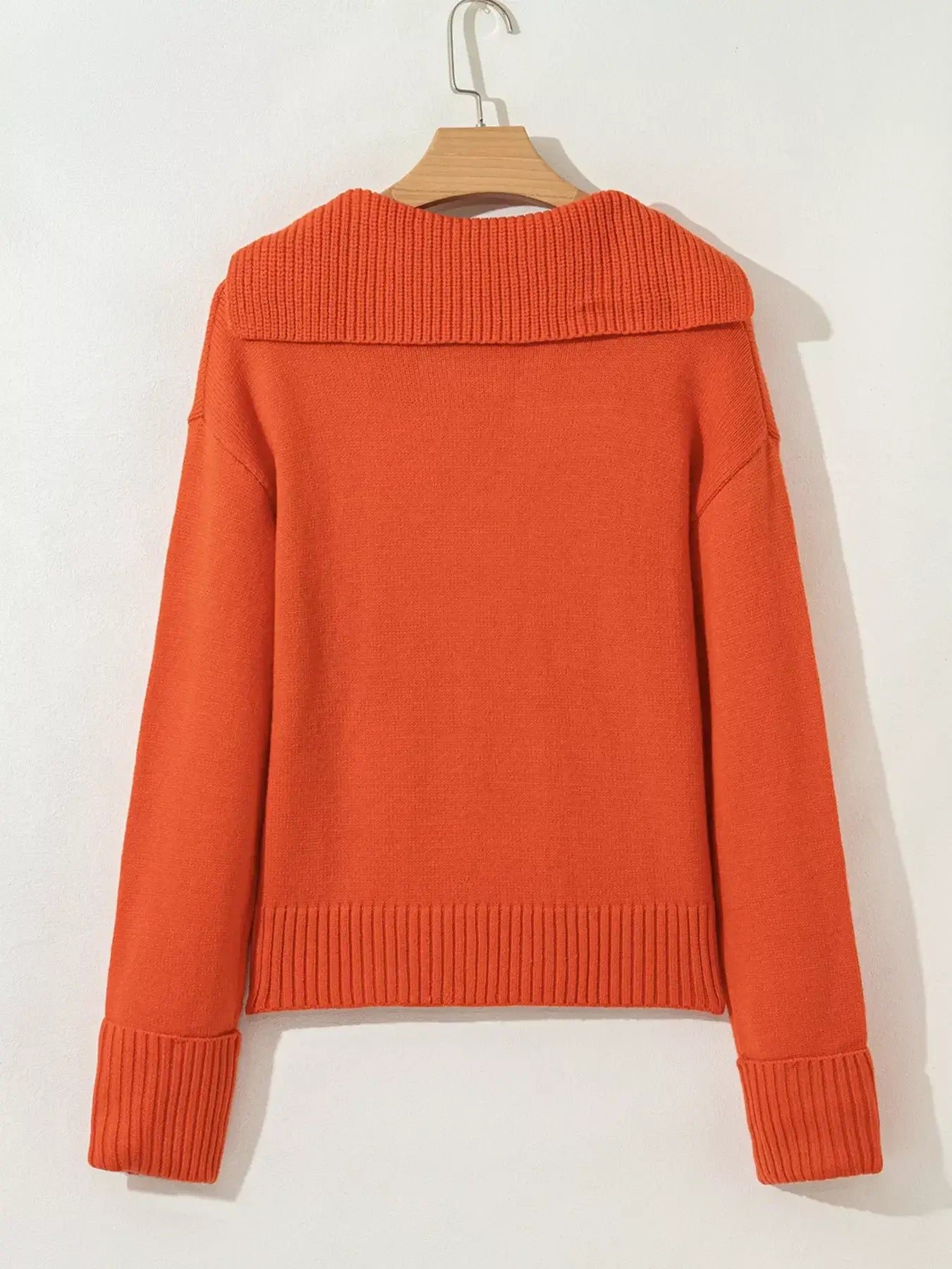 Back view of the collared v neck ribbed edge sweater in bright orange color, showcasing its stylish ribbed edges.
