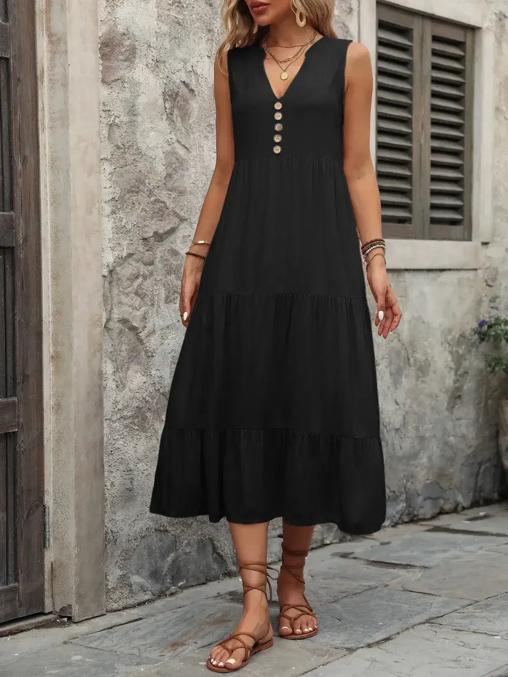 Ivy Lane Decorative Button Notched Sleeveless Dress on a model, featuring a black color and decorative buttons.