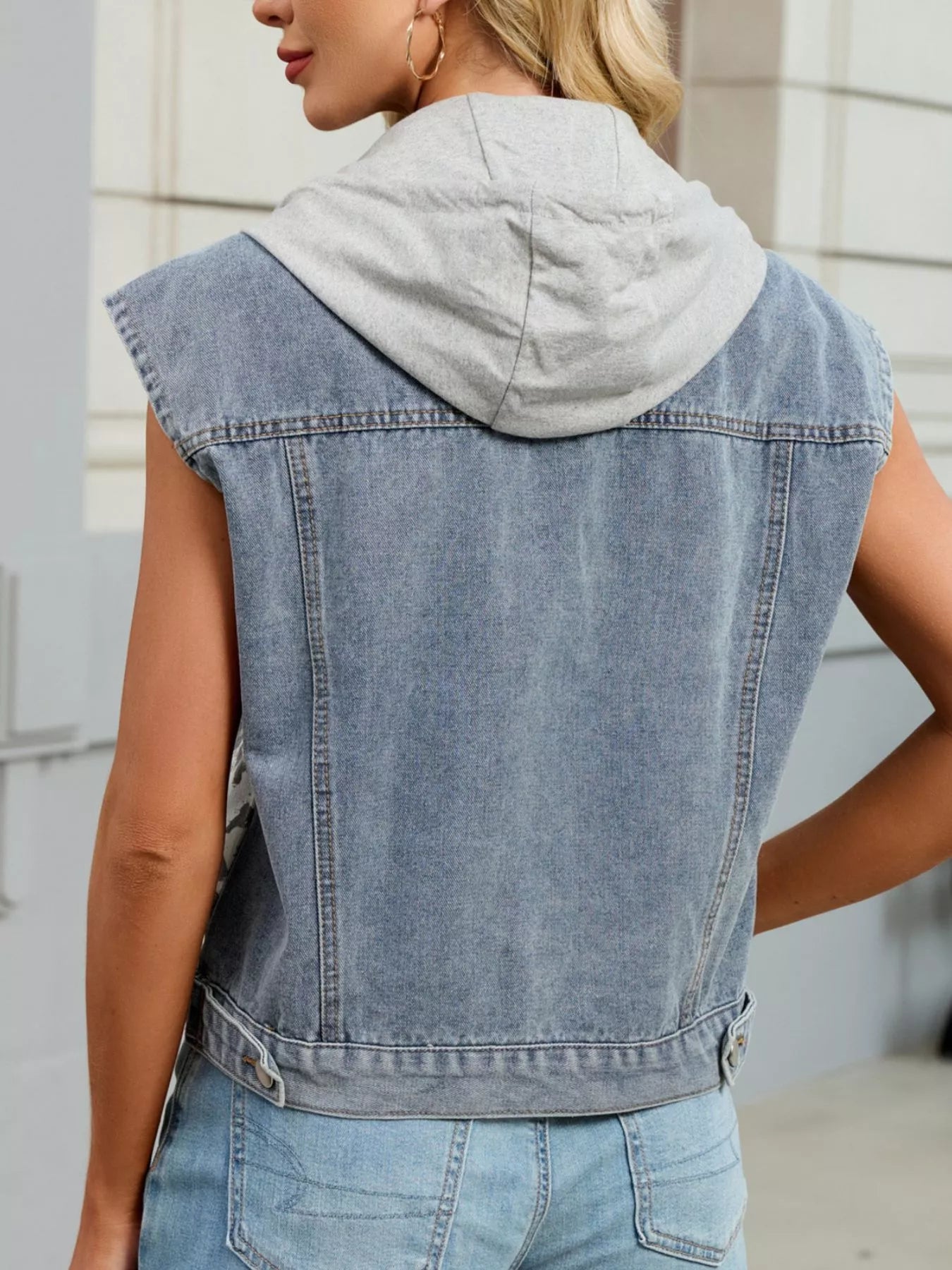 Leopard Button Up Hooded Denim Vest showcasing a stylish back view with a gray hoodie for casual layering.