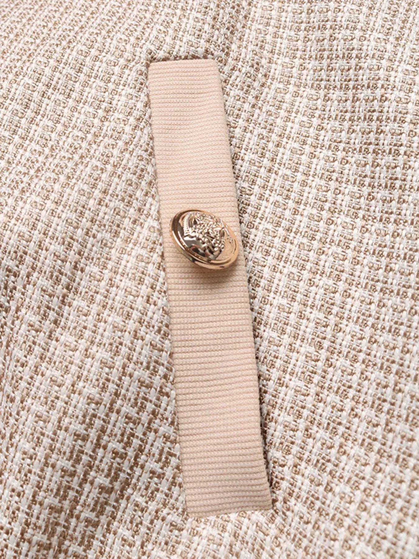 Close-up of the Button Up Long Sleeve Jacket with Pockets for Women featuring a button detail on fabric.