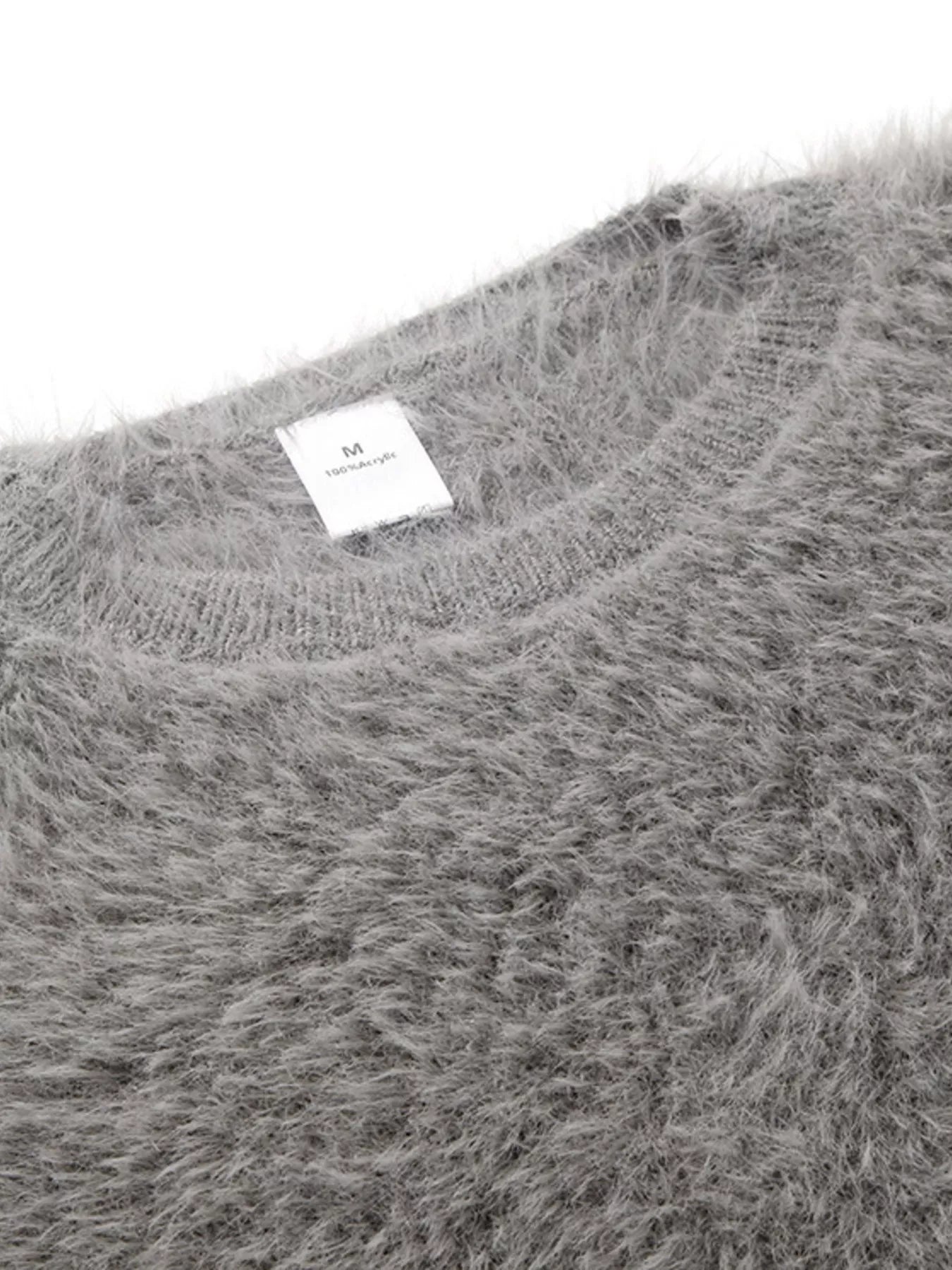 Fuzzy Round Neck Long Sleeve Sweater with a close-up view of the soft gray fabric and label.