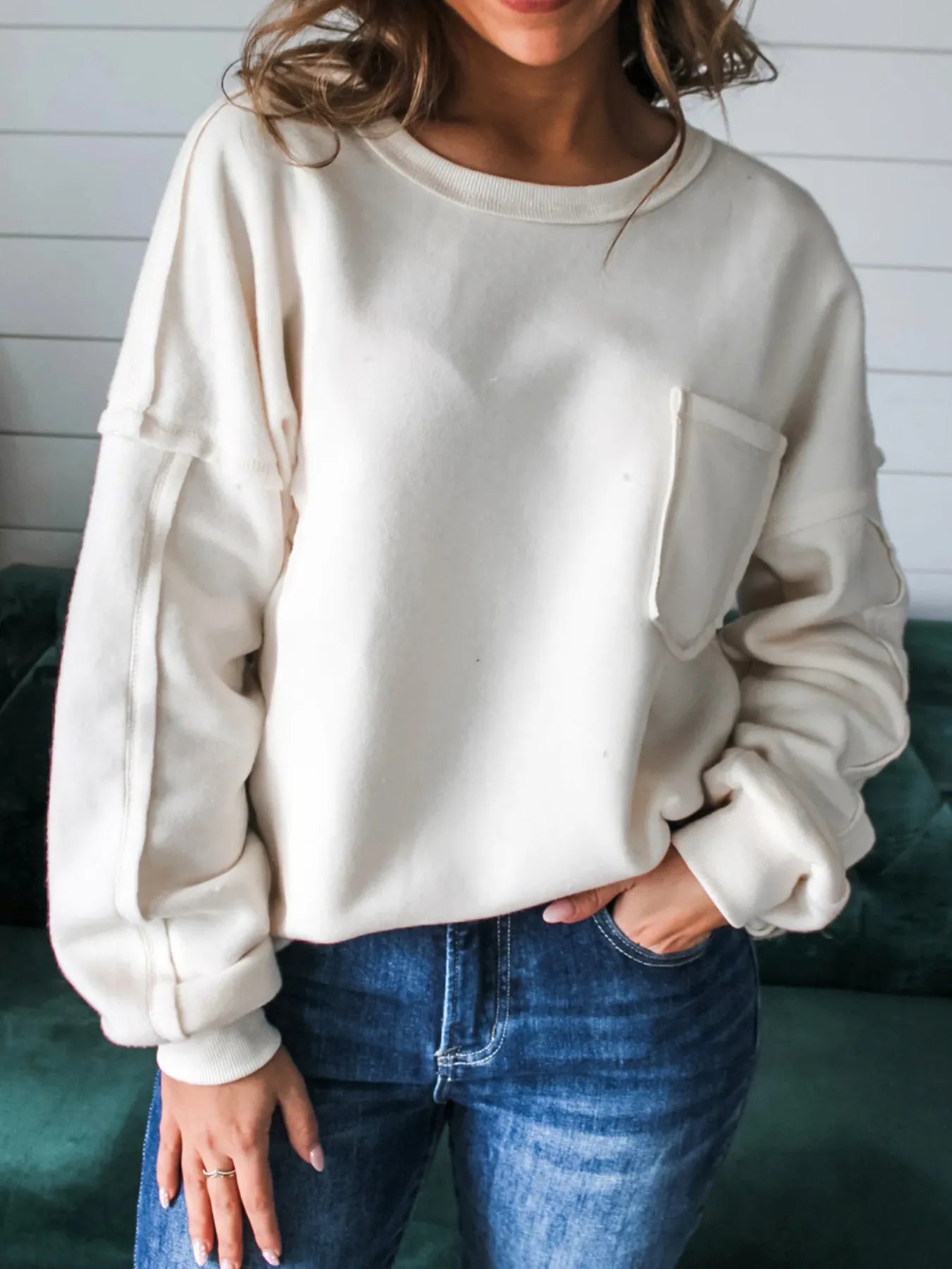 Exposed Seam Chest Pocket Knit Pullover Sweatshirt in cream color with a chest pocket and slightly stretchy material.