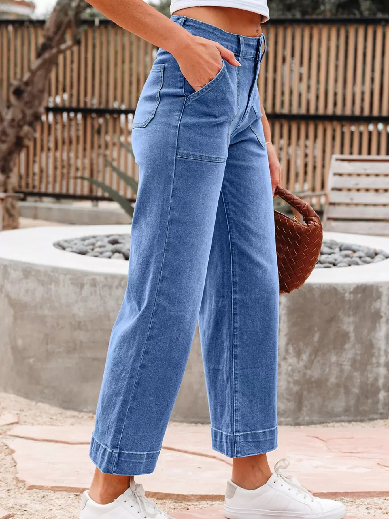 High-Waisted Wide Leg Flare Jeans in light blue with a flared cut and pockets, perfect for a trendy look.