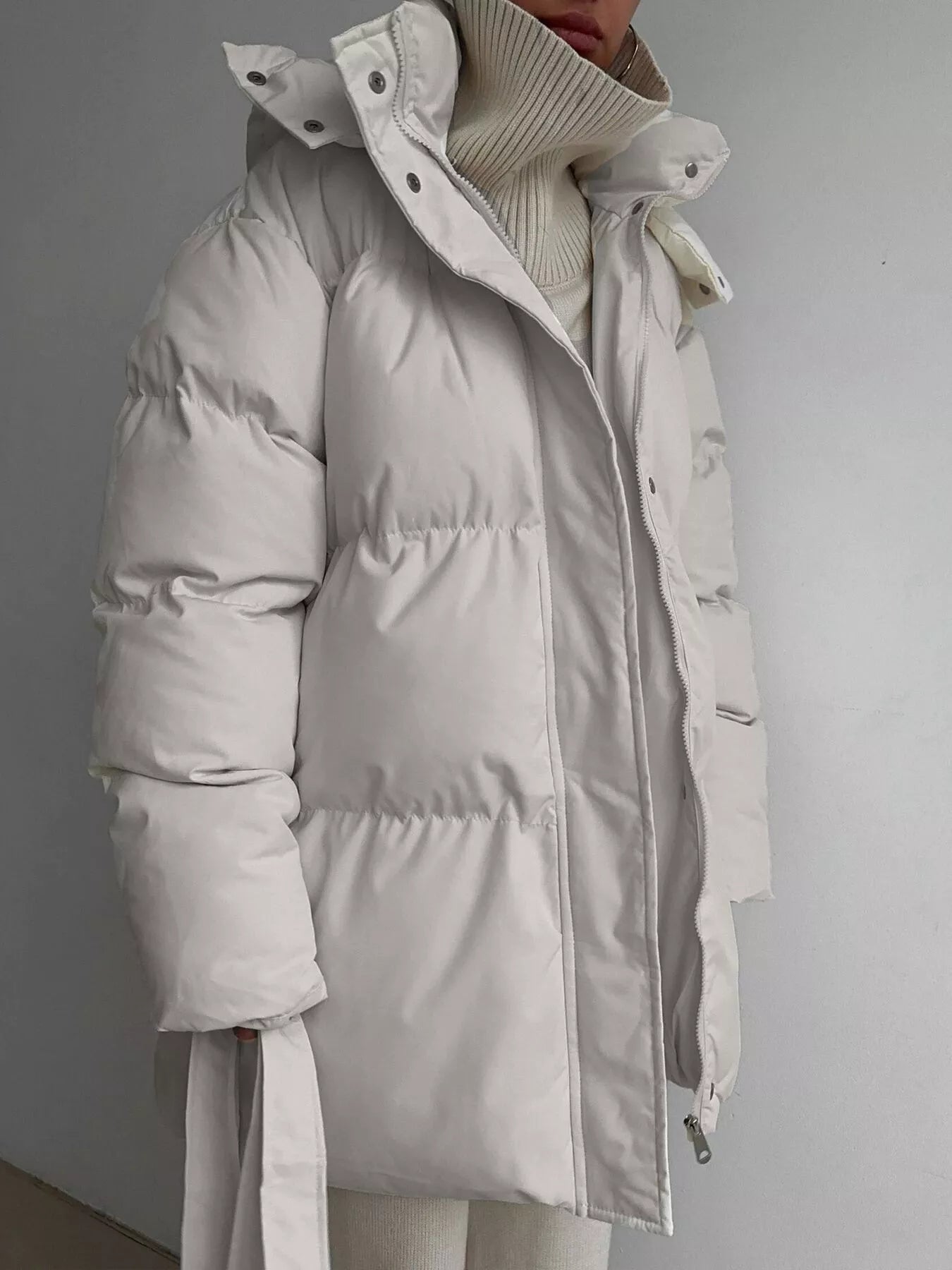 Mid Length Hooded Winter Coat Belted Warm Women Jacket in light color with a stylish design and zipper details.