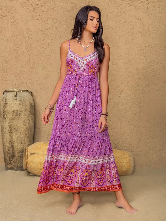 Model wearing a Tassel Floral Print Cami Dress in purple, showcasing boho summer style with floral patterns and tassel details.